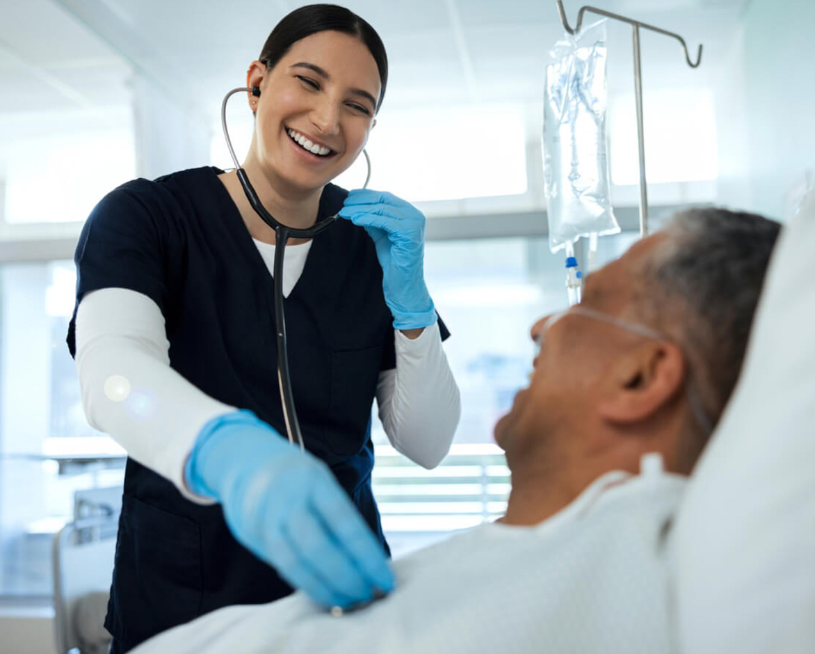 Nurse listening to elder mans heart rate