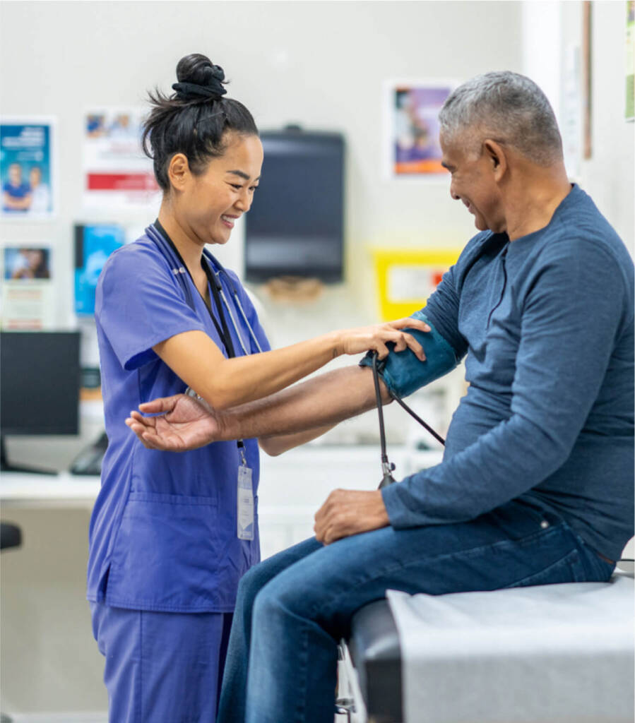 Nurse checking male patients blood pressure