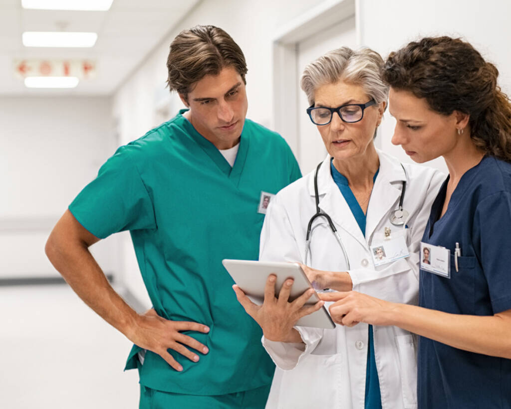 Male and Female nurse looking at ipad with their mentor