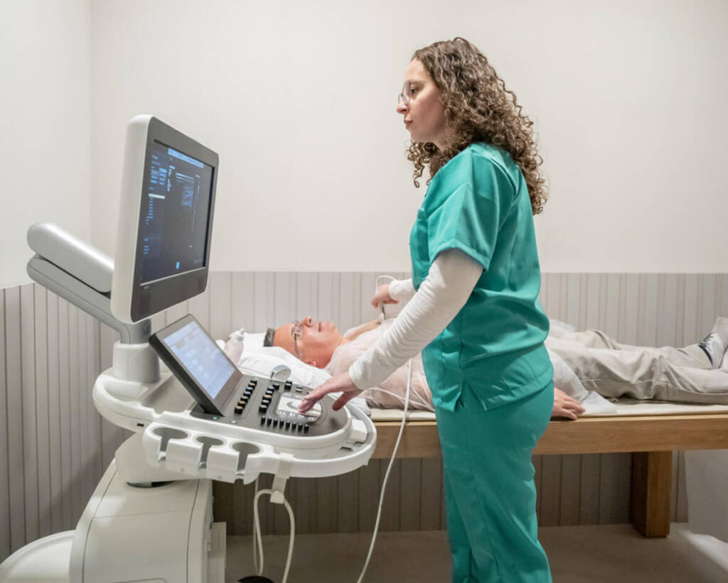 Nurse performing an ultrasound on patient
