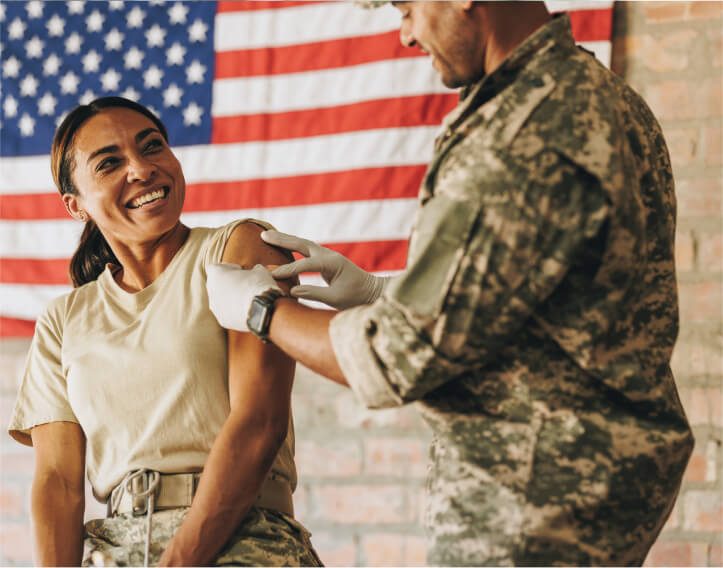 Army nurse giving vaccine to soldier