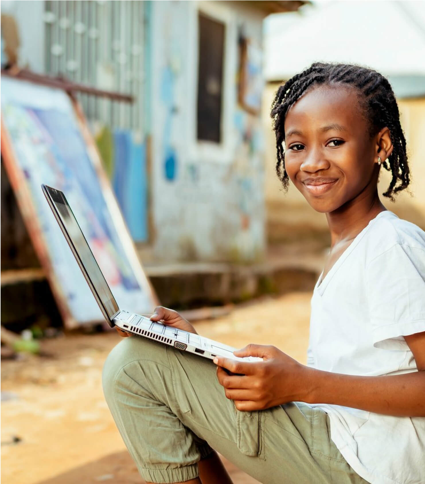 Child using laptop in a third world country