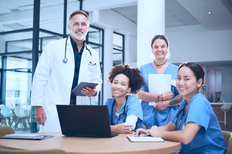 A diverse team of healthcare professionals sitting around a table, sharing ideas and strategies.