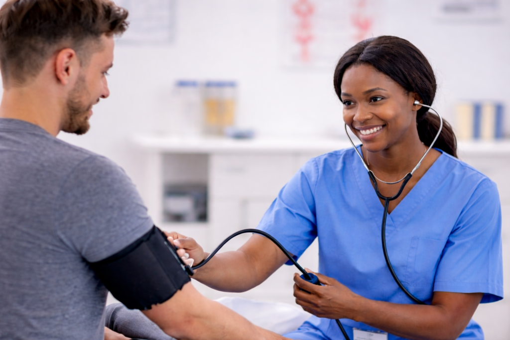 Advanced eClinical Training vs MedCerts comparison showing medical assistant taking a patient’s blood pressure