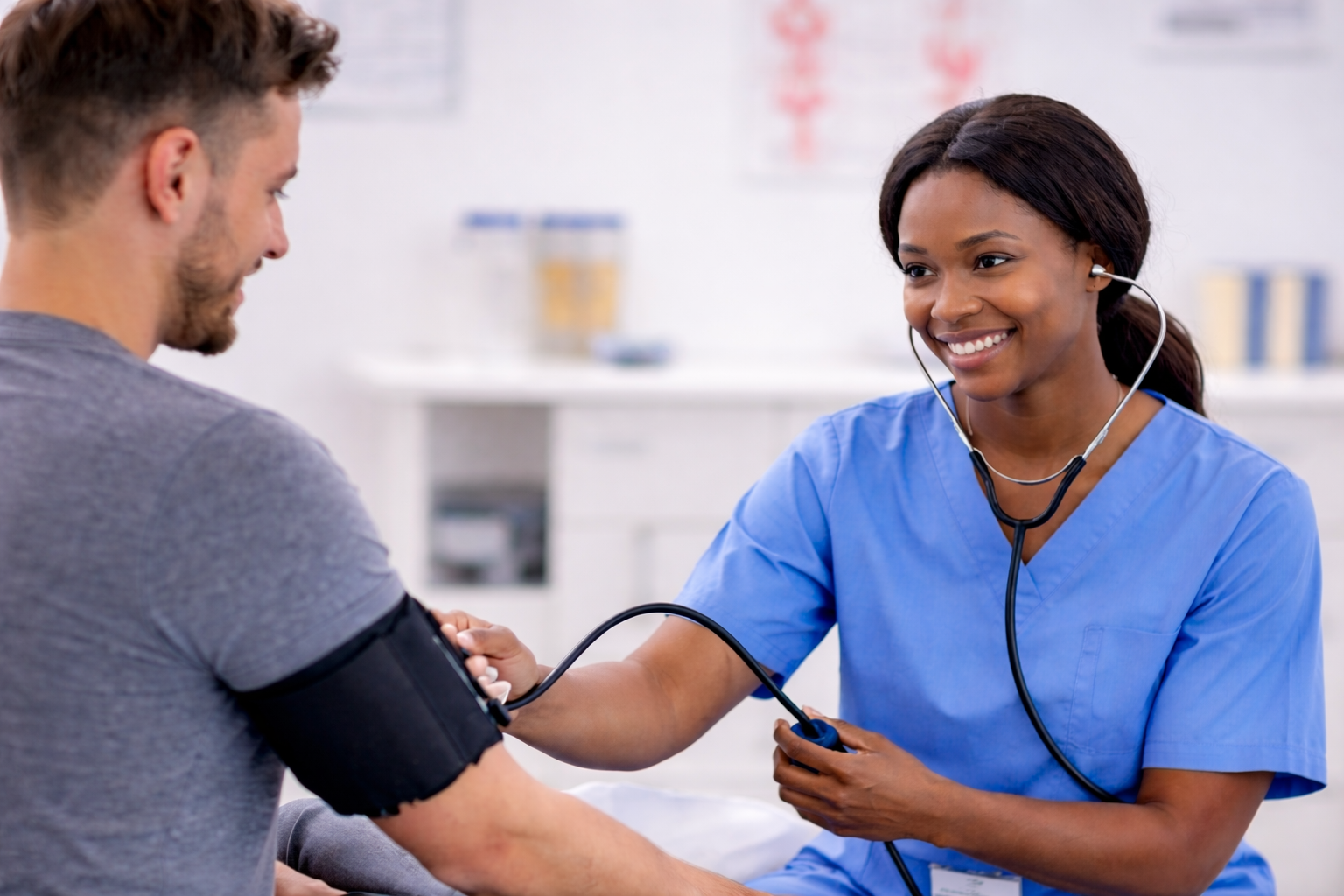 Advanced eClinical Training vs MedCerts comparison showing medical assistant taking a patient’s blood pressure